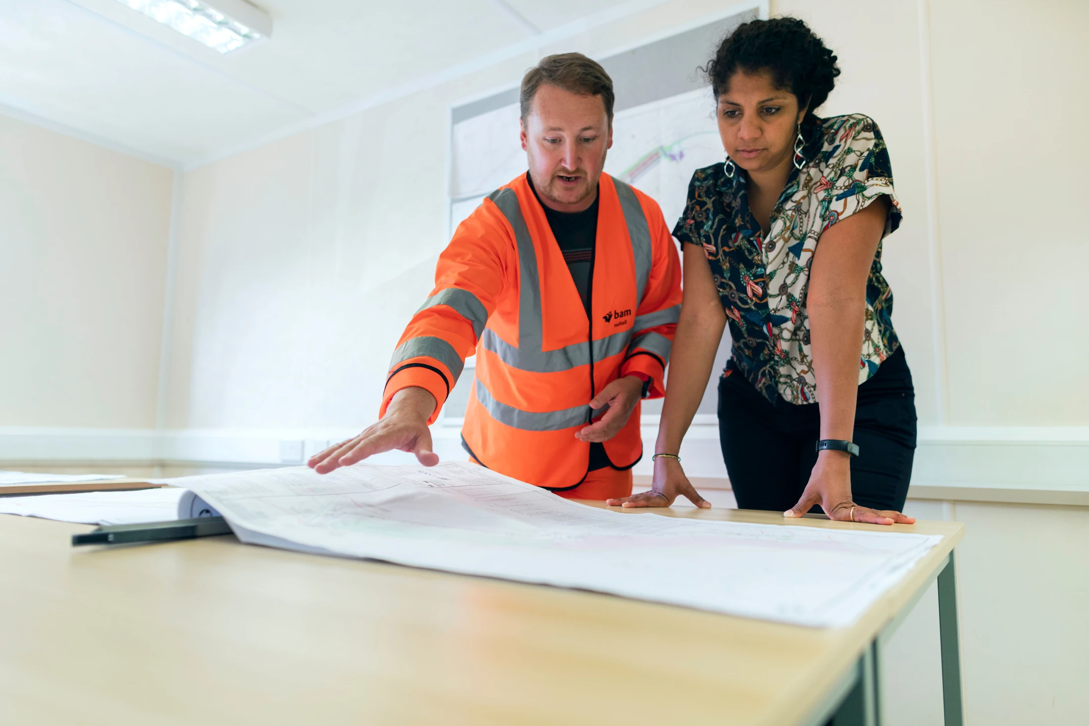 Engineers reviewing paper plans together