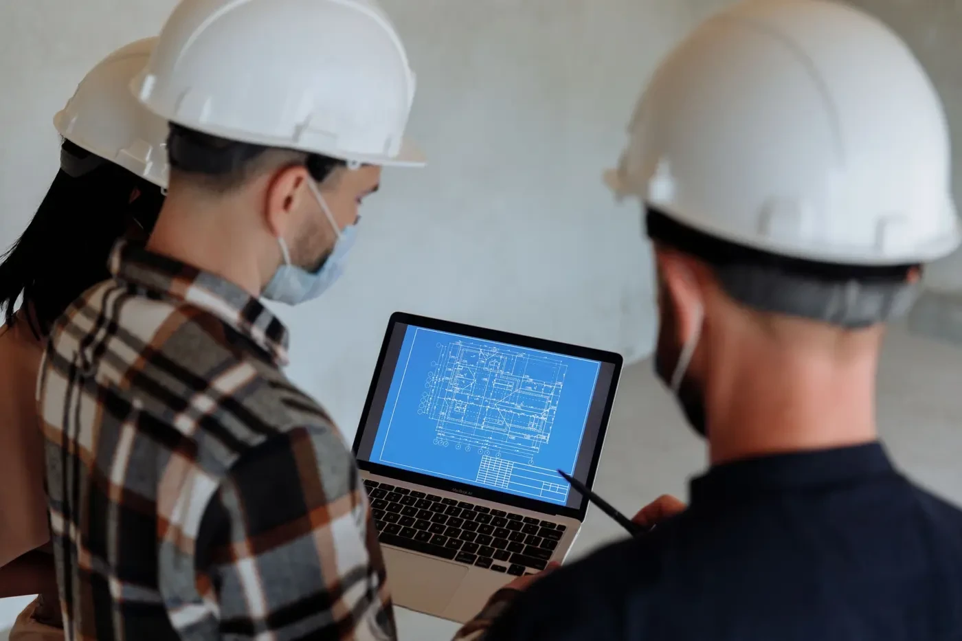 Engineering team examining digital plans